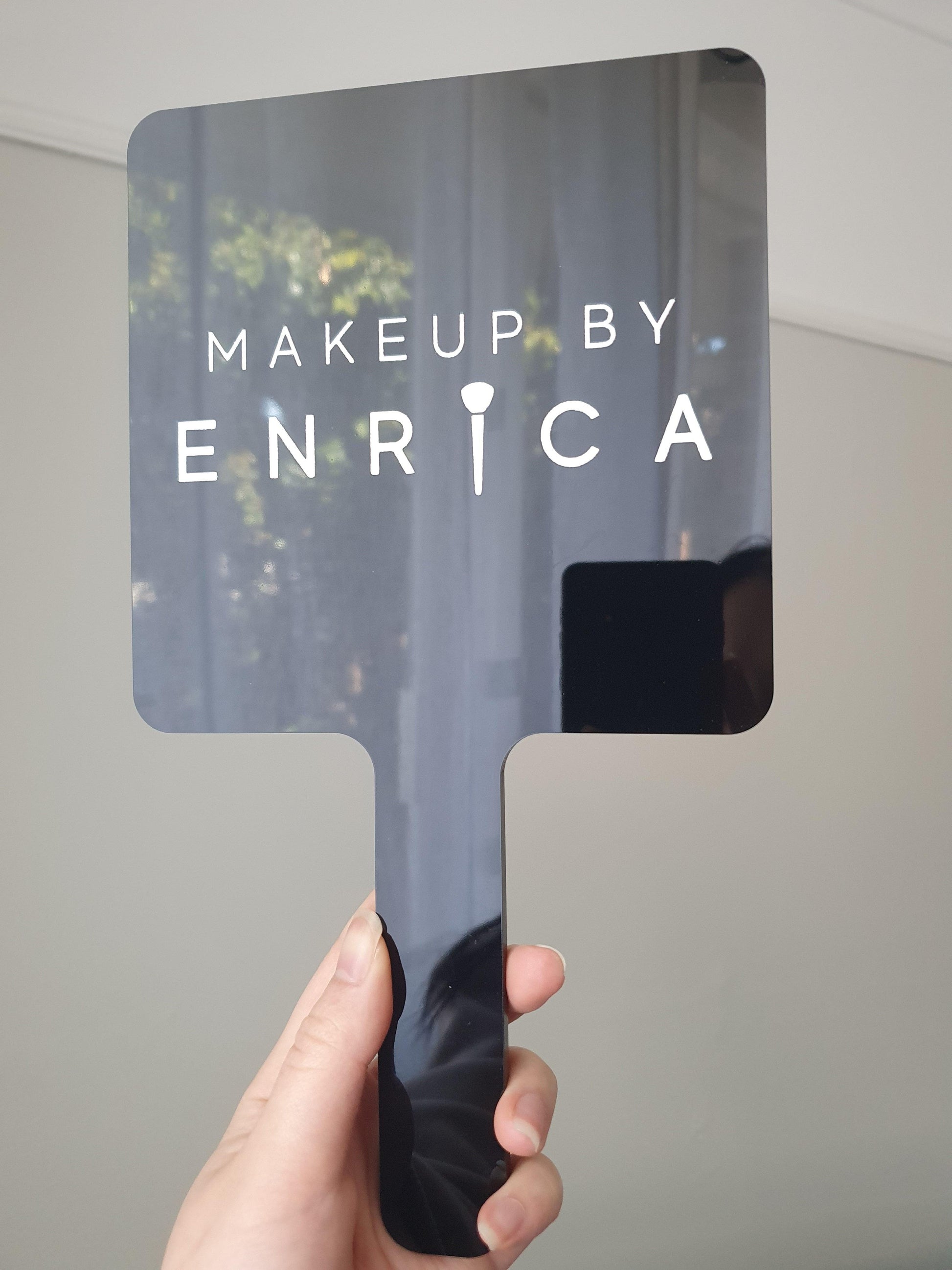 Handheld mirror with engraing and logo
