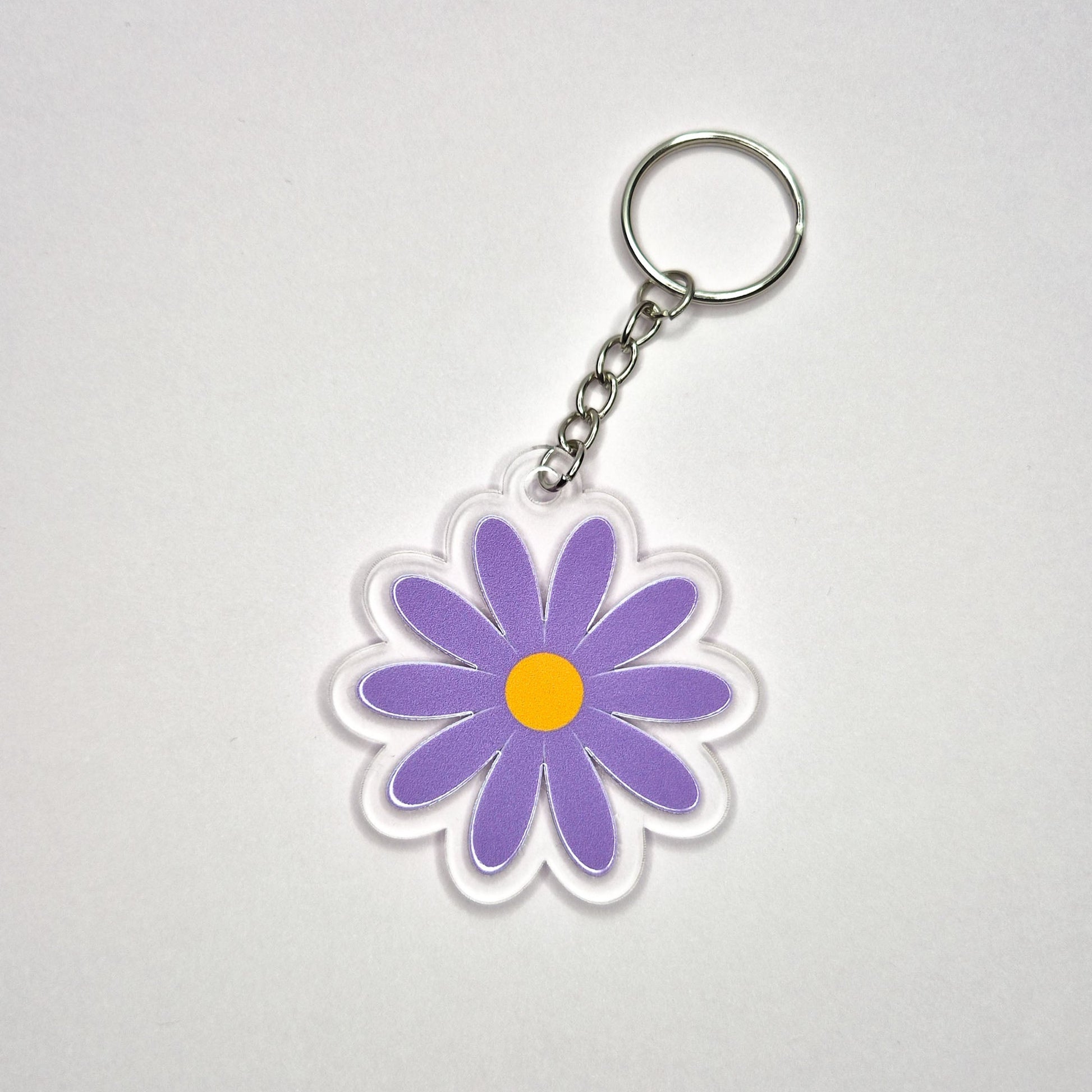 Keychain with a purple flower design on a white background