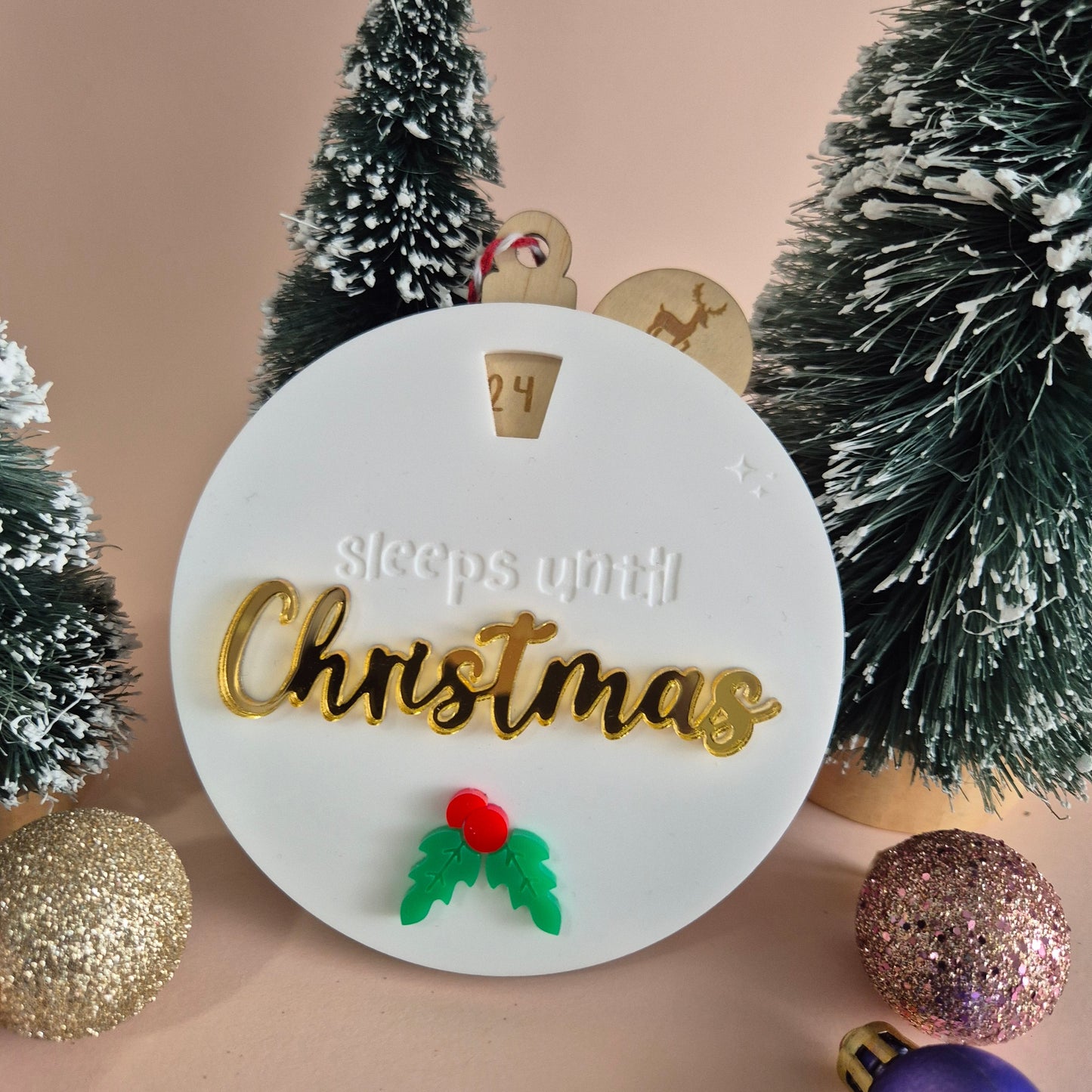 Christmas countdown ornament with trees and ornaments on a beige background