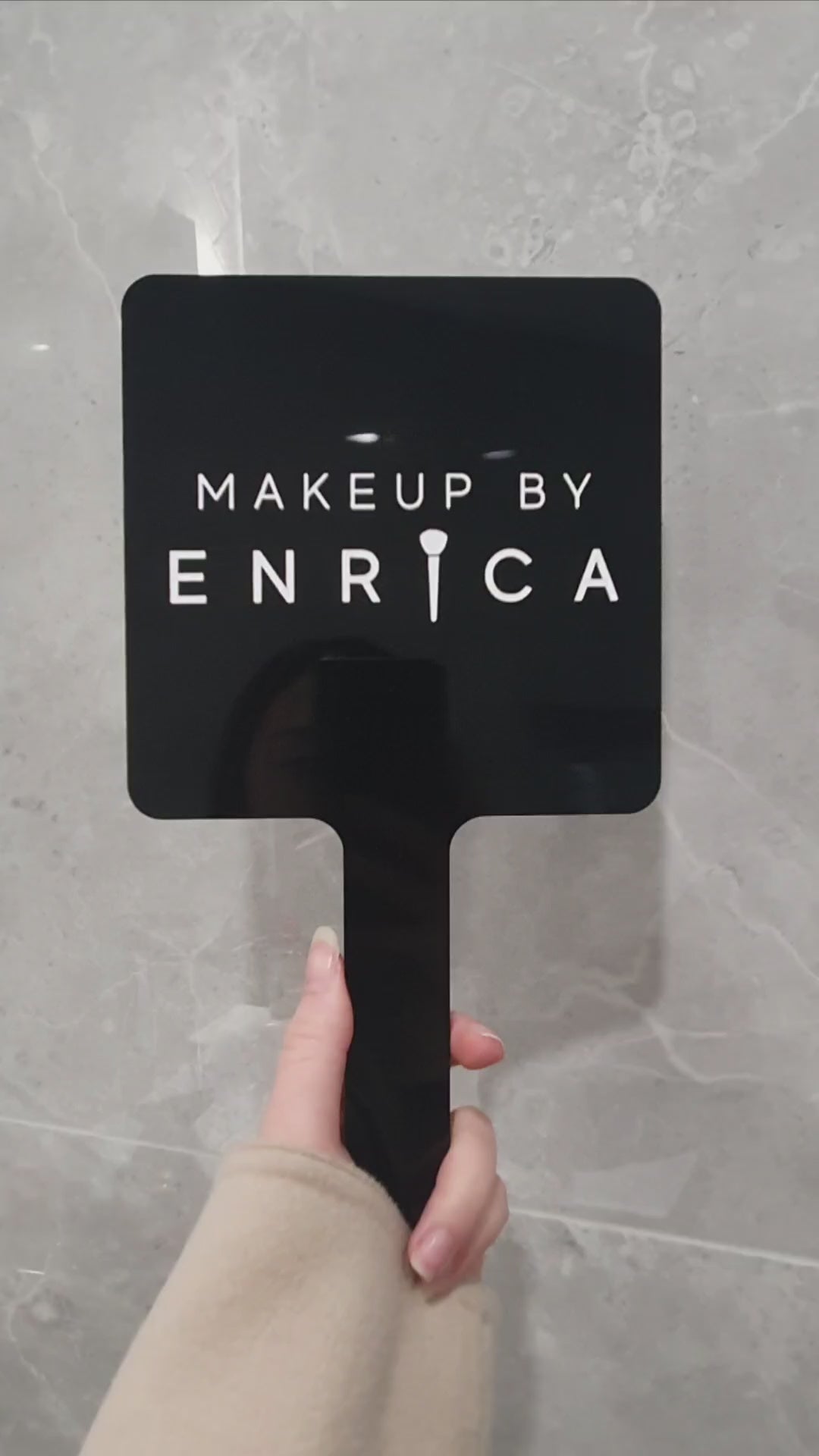 Video of handheld mirror with engraved logo